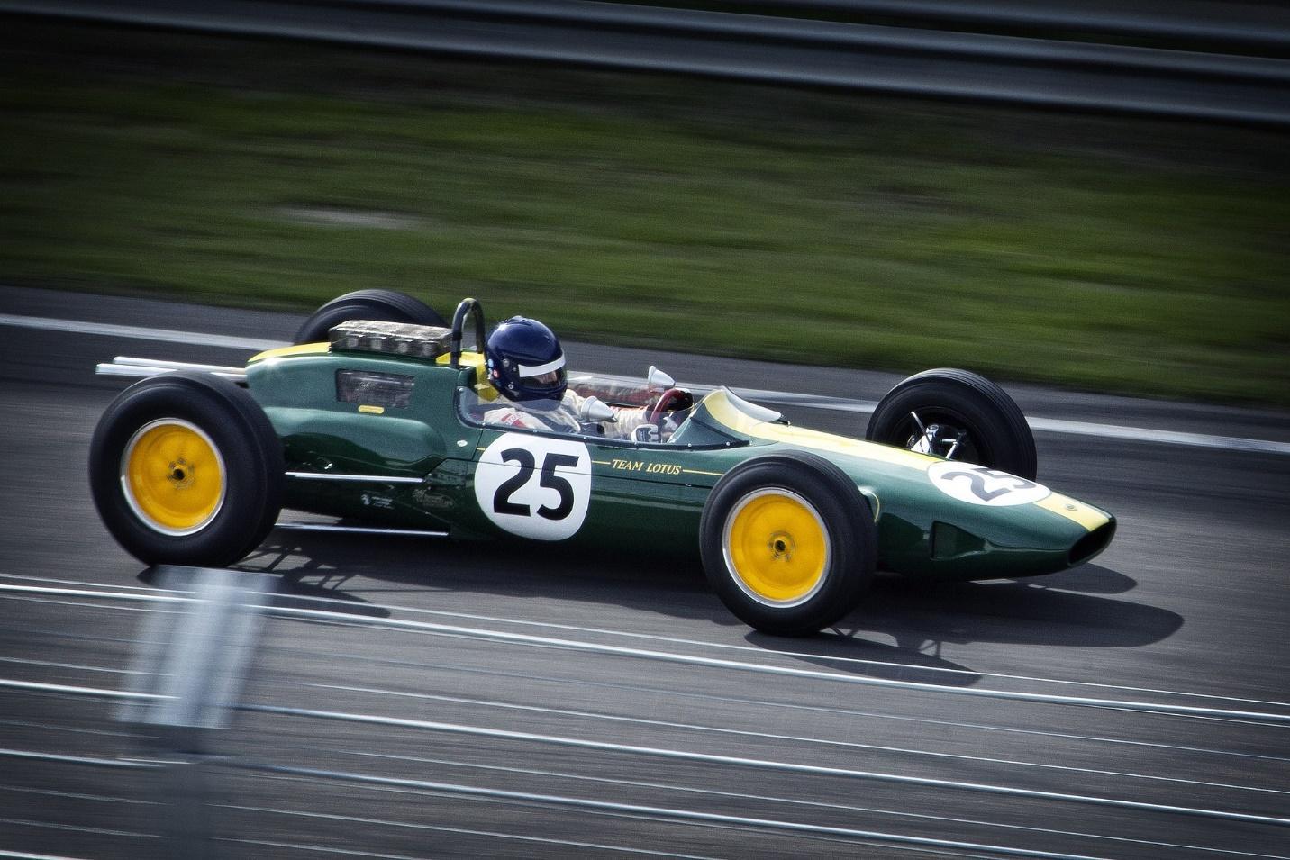 A green Formula 1 car racing on a track. Free photo on Pixabay